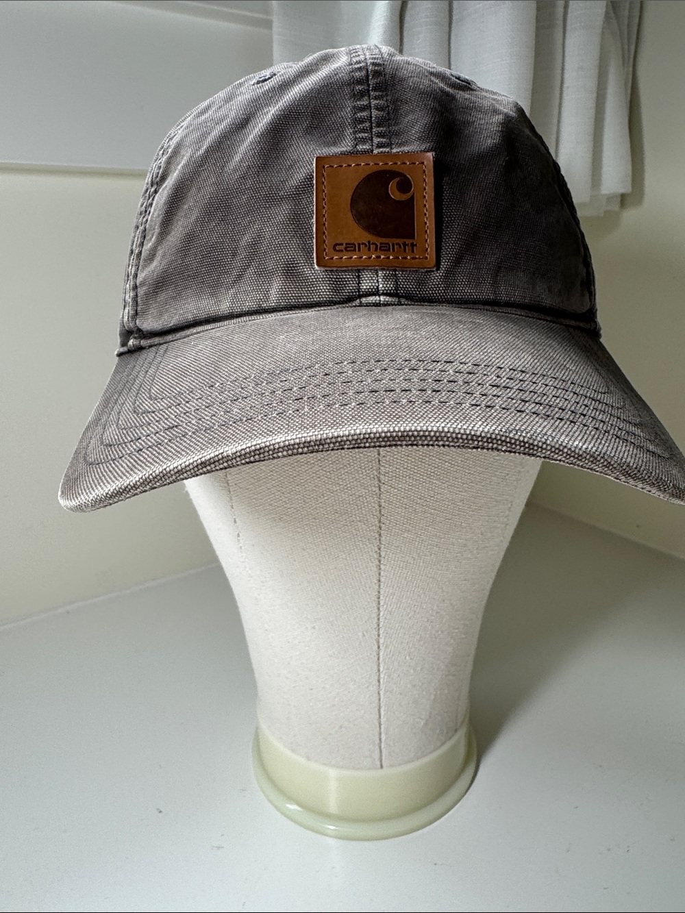 Gray Carhartt ball cap.